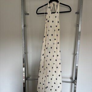 Reformation open back halter maxi dress in a cream base with navy hibiscus flora